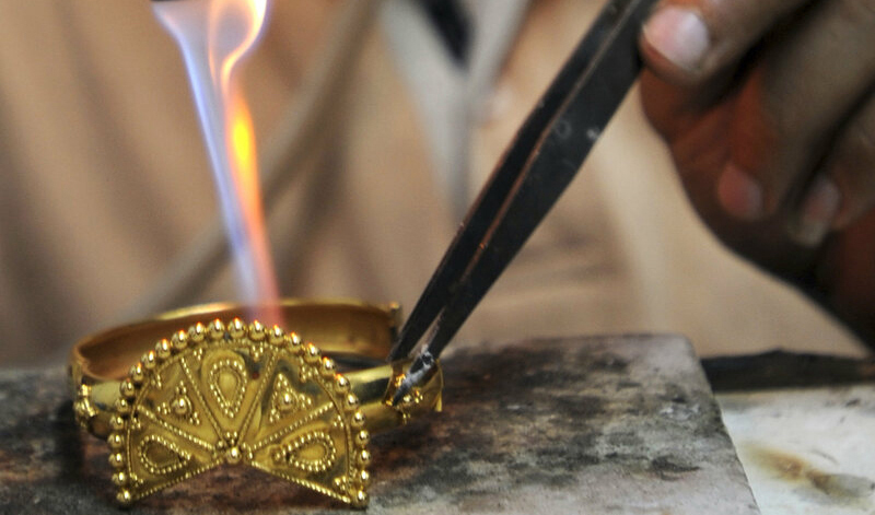A goldsmith works on gold ornaments inside a jewellery workshop in Cairo May 20, 2010. 
Credit: Mohamed Abd El-Ghany/REUTERS